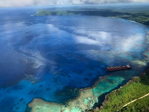 A large oil slick emanates from the the MV Solomon Trader after it ran aground near Rennell Island on Feb. 5. The oil has contaminated the ecologically delicate area in the Solomon Islands. Image courtesy of Australian Dept of Foreign Affairs & Trade.